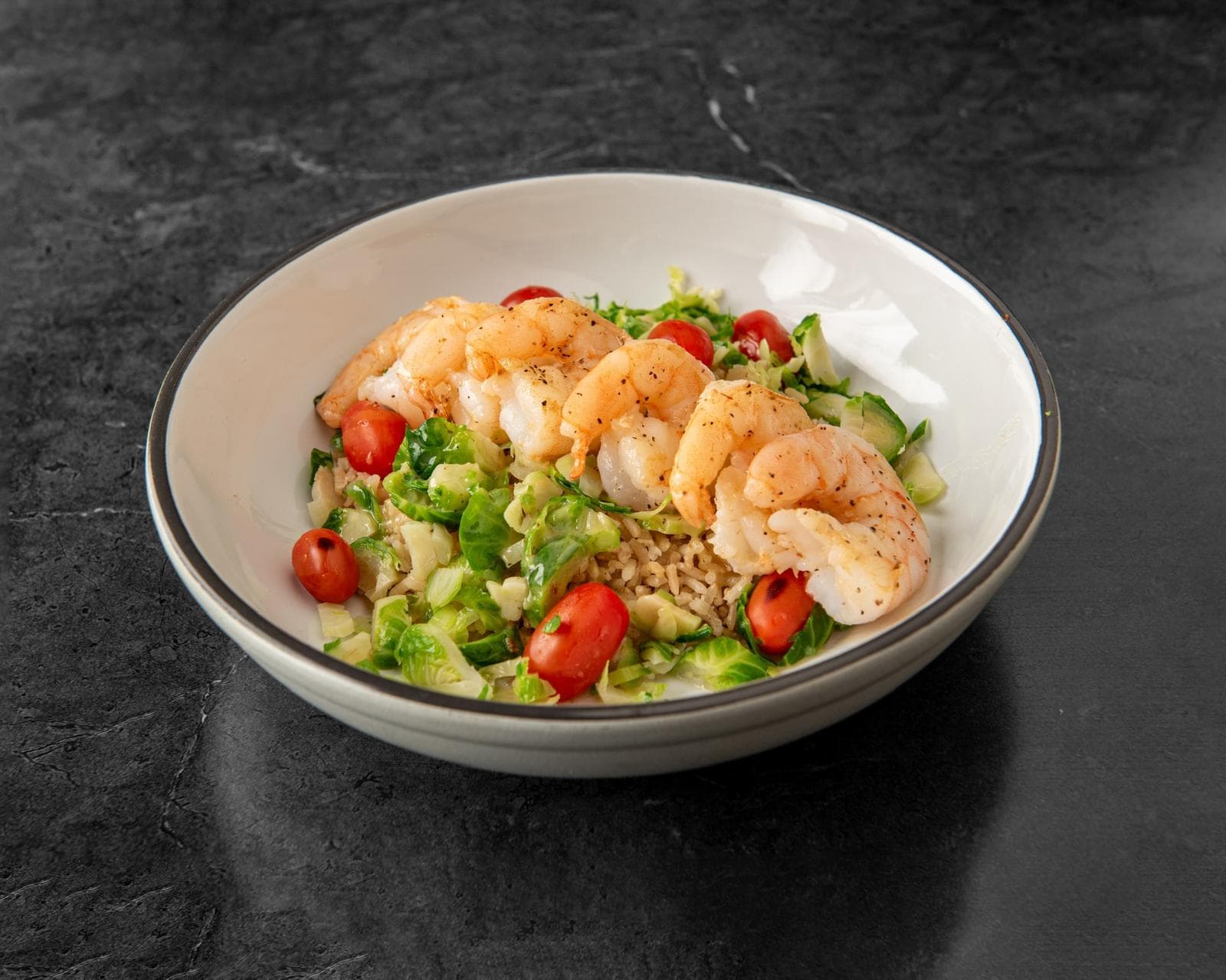 Sautéed shrimp bowl with brussels sprouts, tomatoes and brown rice