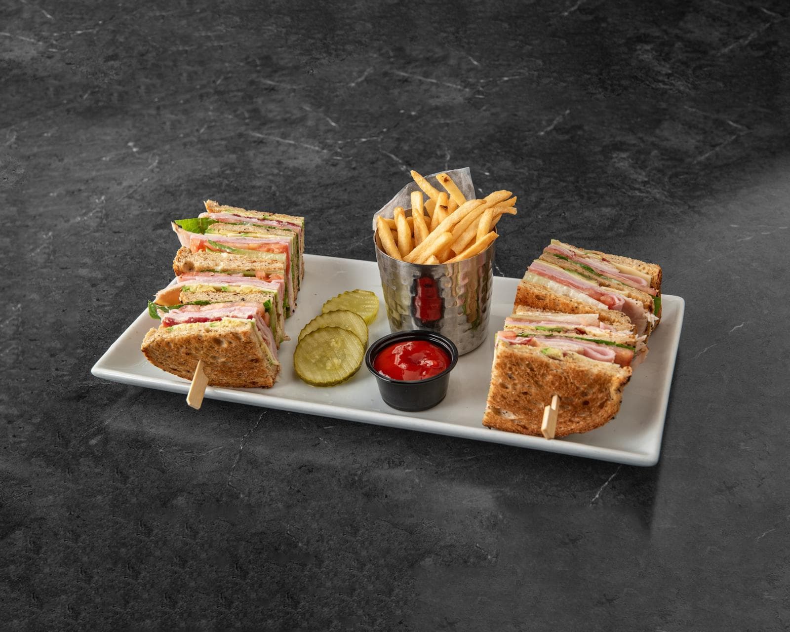 Triple Decker Club stacked on toasted sourdough with fries