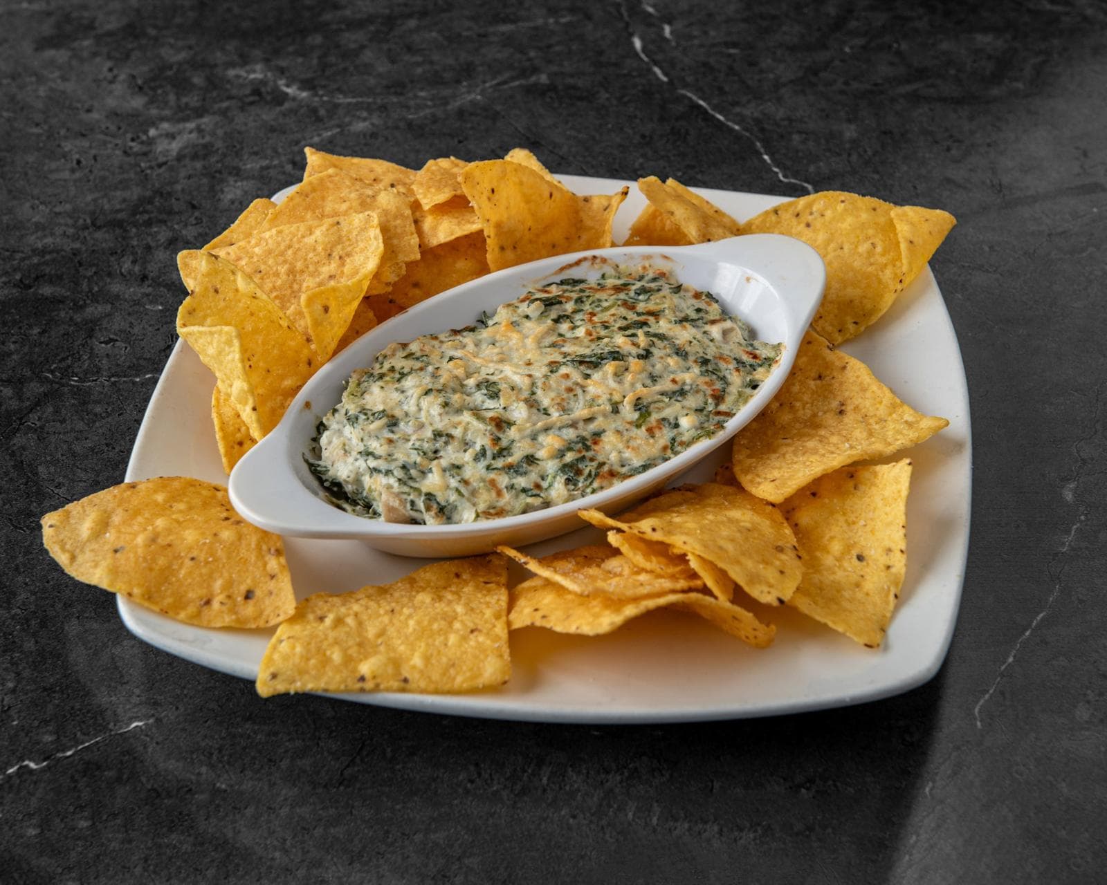 Spinach and artichoke dip served with tortilla chips