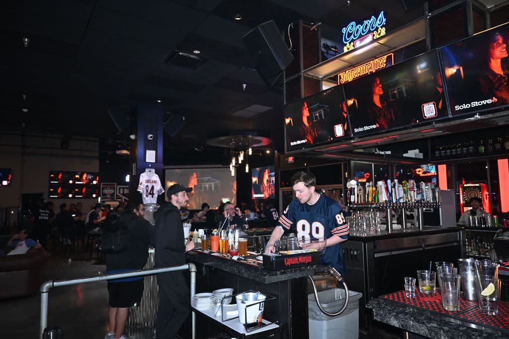Bartenders in Bears jerseys working the bar